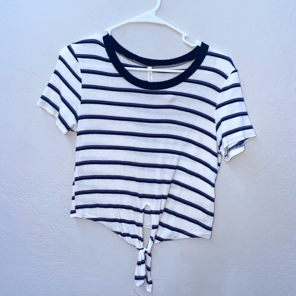 Color is white, has a thin purple line and black pattern too! Size small